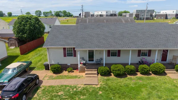an aerial view of a house with a yard