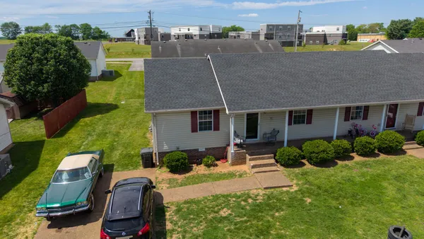 an aerial view of a house with a yard basket ball court and outdoor seating