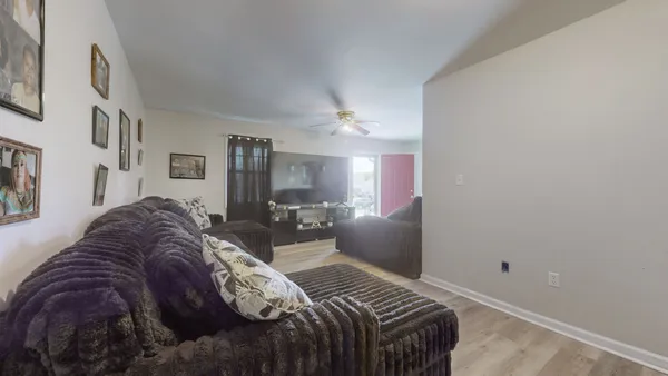 a bedroom with a bed a dresser next to a window