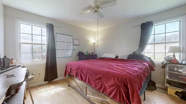 a bedroom with a large bed and a flat tv screen