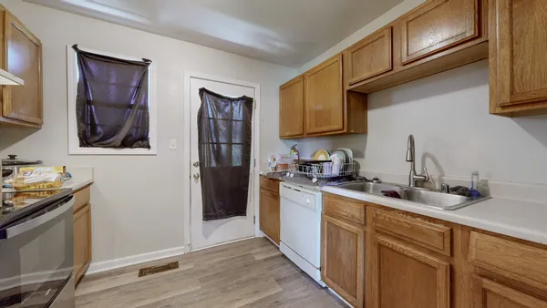 a kitchen with stainless steel appliances granite countertop a refrigerator and a stove