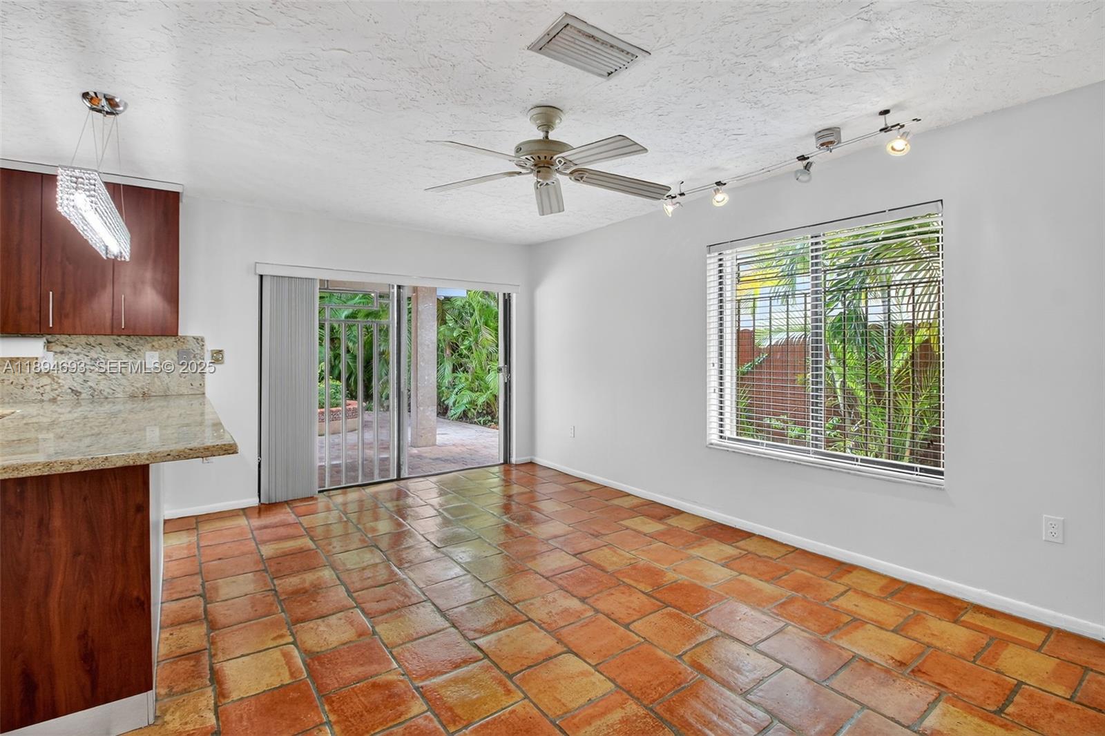 13830 Southwest 108th Street Miami, FL 33186 - Photo 16 of 40 a view of an entryway with a chandelier