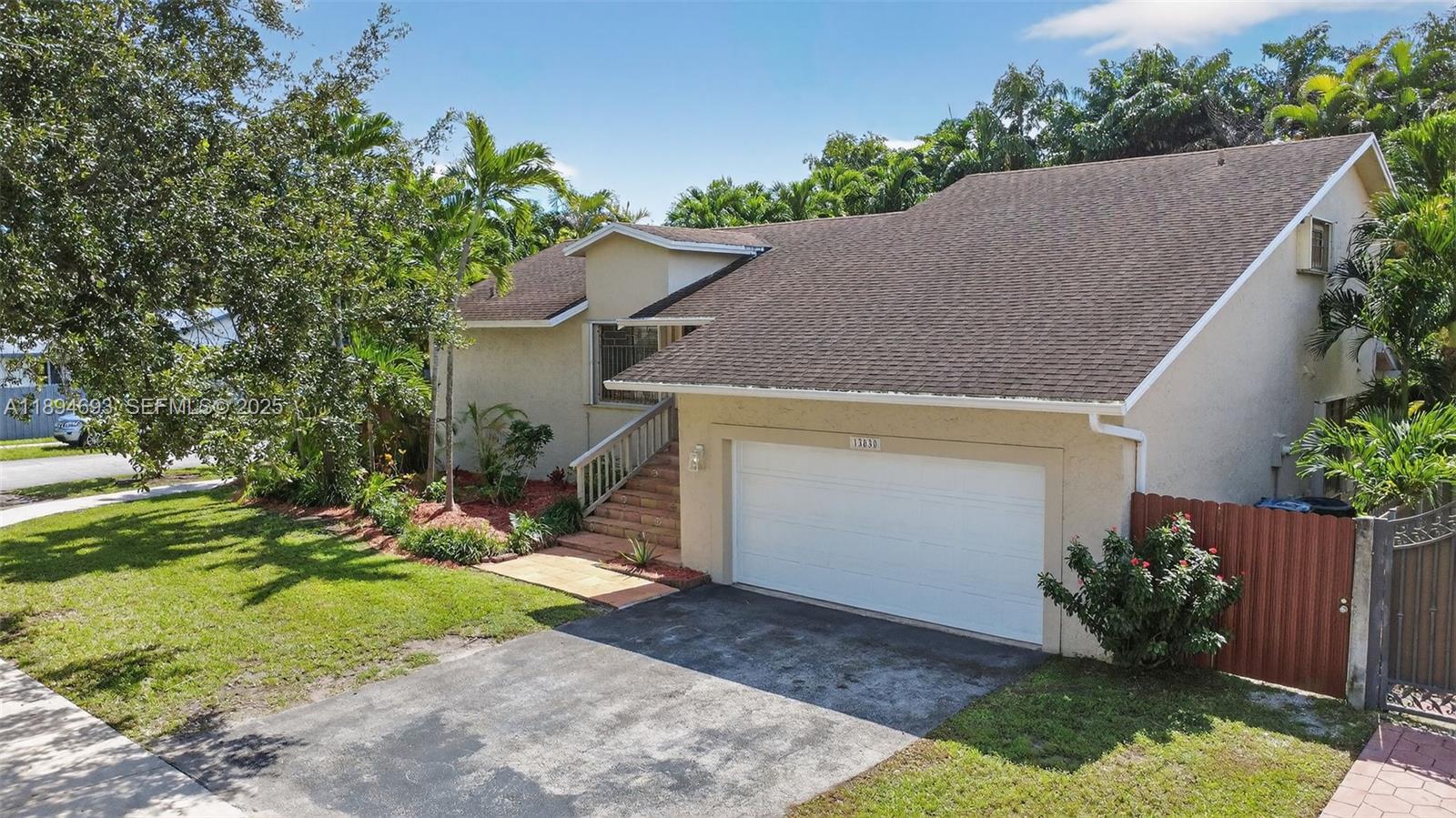 13830 Southwest 108th Street Miami, FL 33186 - Photo 2 of 40 front view of house with a yard