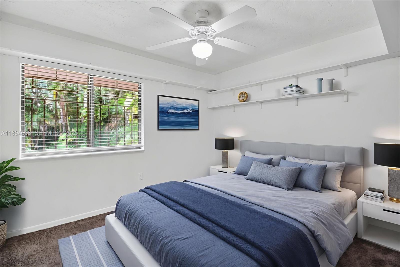 13830 Southwest 108th Street Miami, FL 33186 - Photo 31 of 40 a bedroom with a bed and a large window