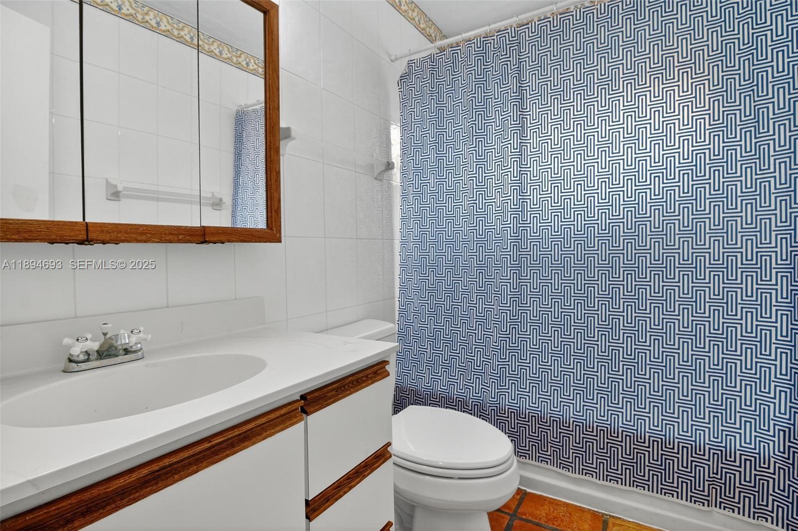 13830 Southwest 108th Street Miami, FL 33186 - Photo 32 of 40 a bathroom with a sink a toilet and shower