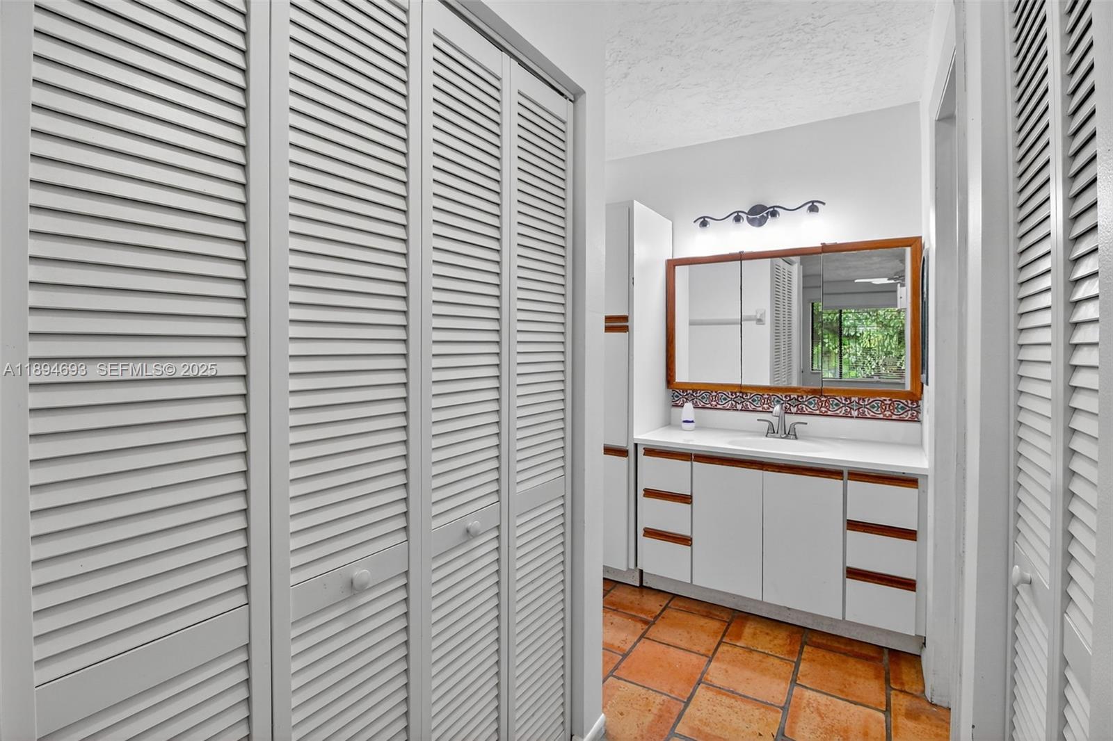 13830 Southwest 108th Street Miami, FL 33186 - Photo 33 of 40 a bathroom with a window sink and vanity