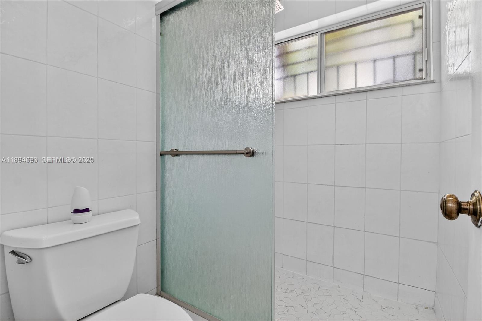 13830 Southwest 108th Street Miami, FL 33186 - Photo 34 of 40 a bathroom with a toilet and shower