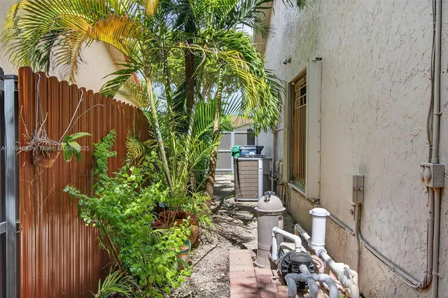 view of a backyard with plants and tub