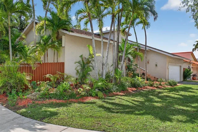 an aerial view of a house with a yard and garden