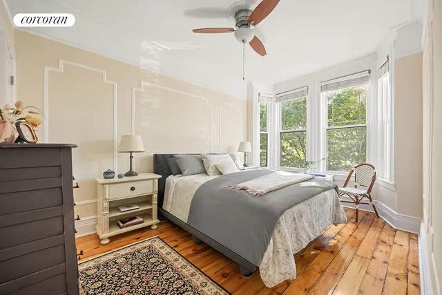 a bed room with a bed and a chair