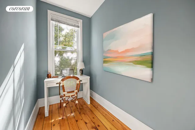 a workspace with wooden floor and a window