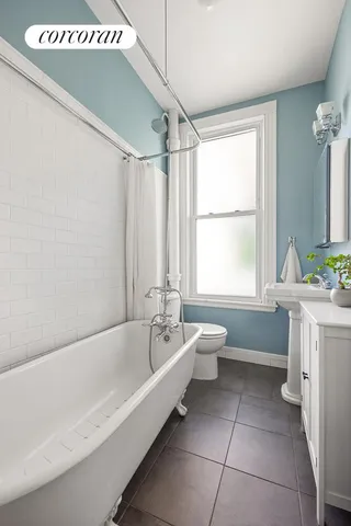 a spacious bathroom with a bathtub sink and toilet