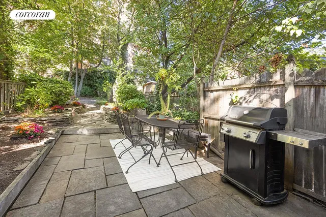 a view of a patio with table and chairs and potted plants
