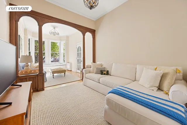a living room with furniture and large windows