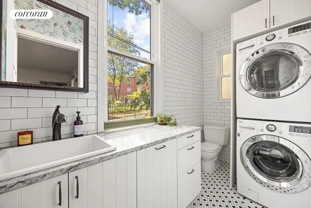a utility room with sink dryer and washer