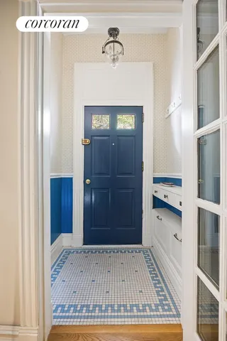 a view of a hallway with wooden floor and cabinet