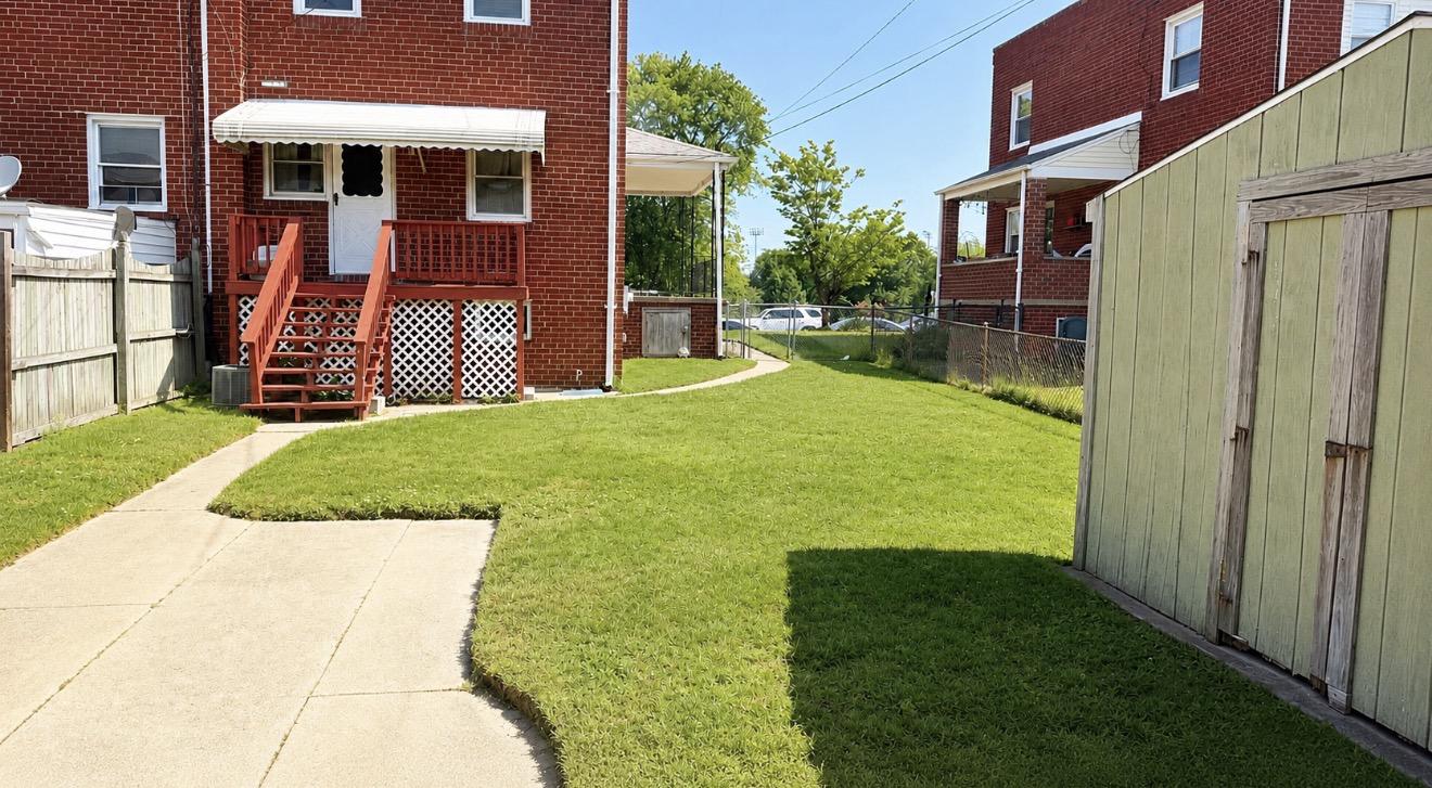 8027 Park Haven Road Dundalk, MD 21222 - Photo 2 of 13 Charming backyard with lush greenery.
Edit with AI
