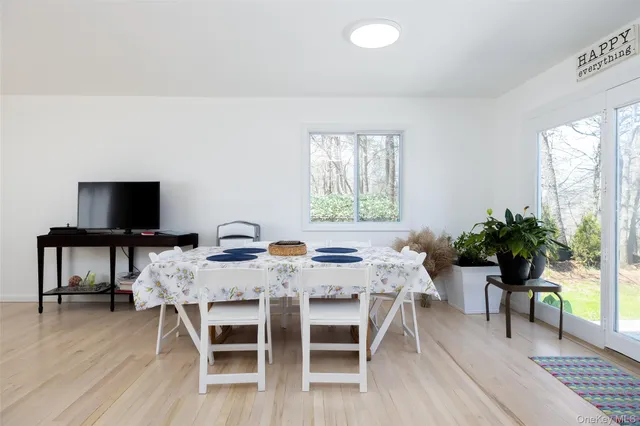 a view of a dining room with furniture window and wooden floor