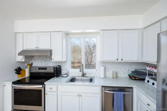 a kitchen with a sink stove and cabinets