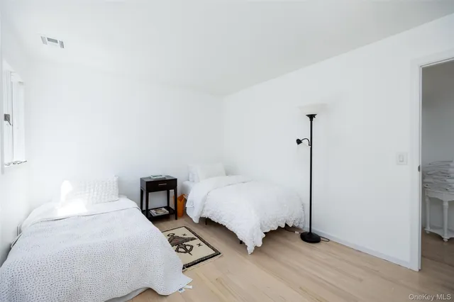 a bedroom with a bed and a night stand