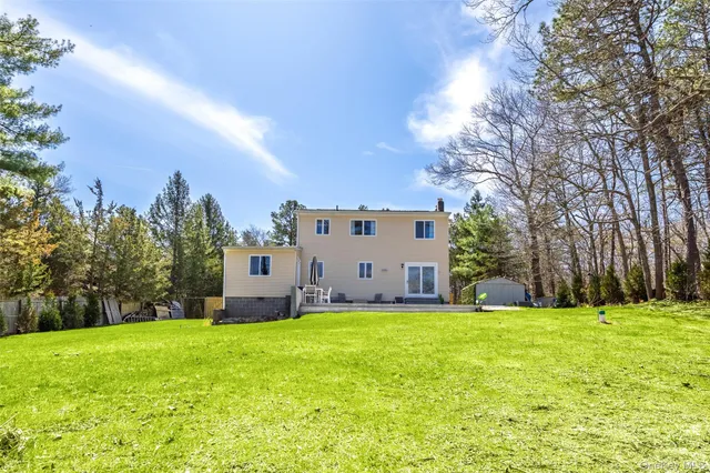 a house view with a sitting space and garden