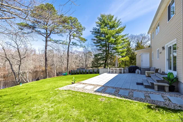 a view of a backyard with plants and patio