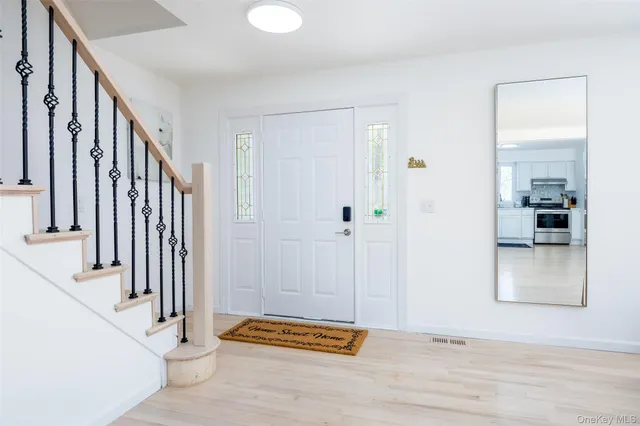 a view of an entryway with wooden floor