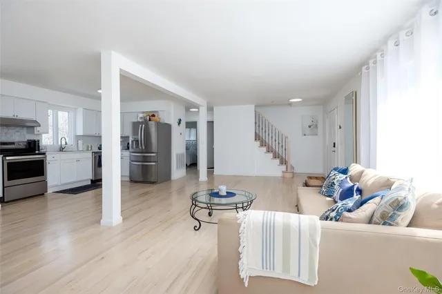 a kitchen with stainless steel appliances kitchen island granite countertop a refrigerator and a stove