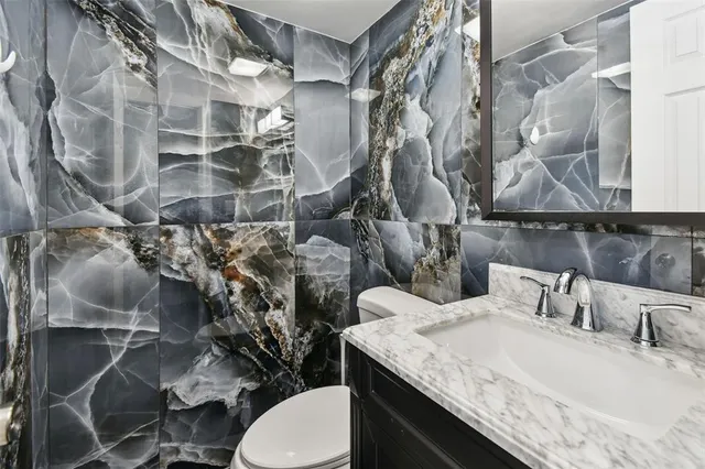 a view of kitchen with stainless steel appliances granite countertop a stove a sink and a refrigerator