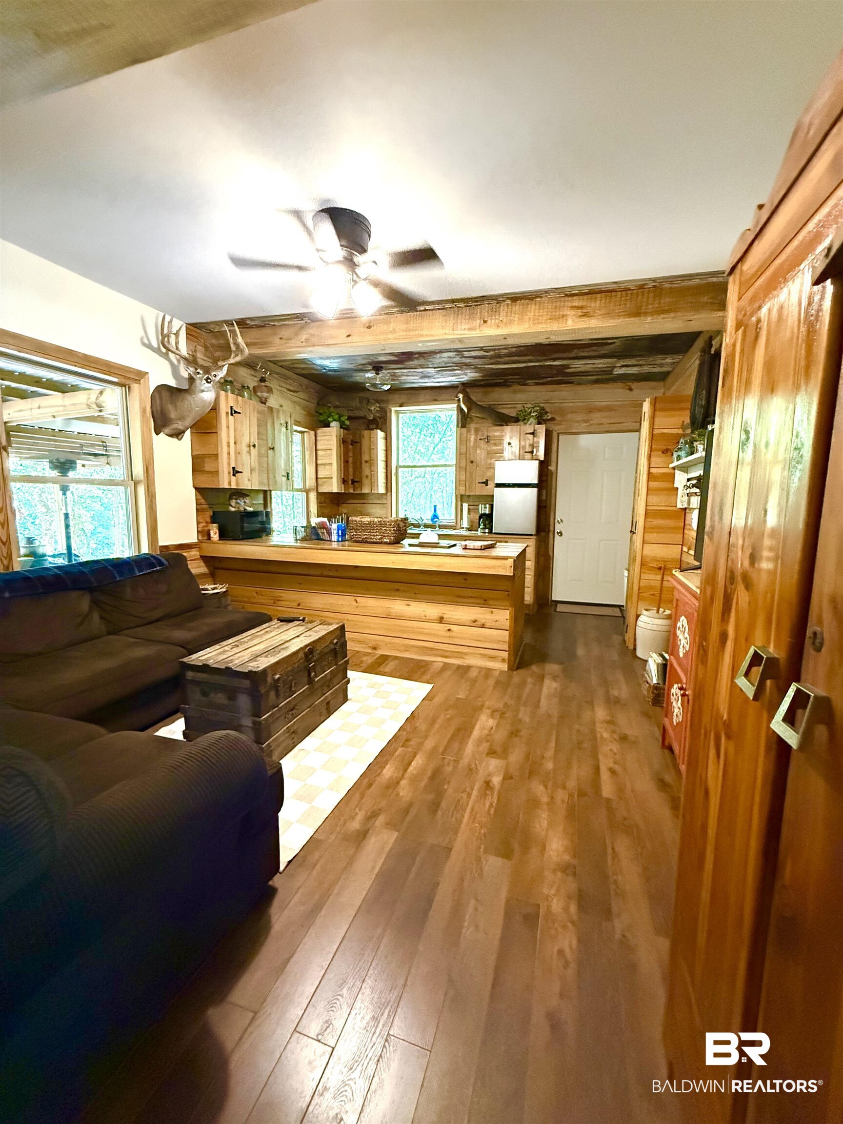 1 Mason Ferry Road Citronelle, AL 36522 - Photo 8 of 40 Open concept living space featuring wood-finish flooring, natural wood walls, and exposed ceiling beams