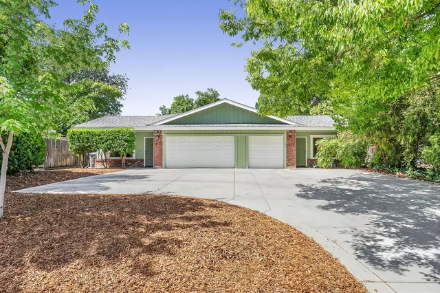 a front view of a house with a garden