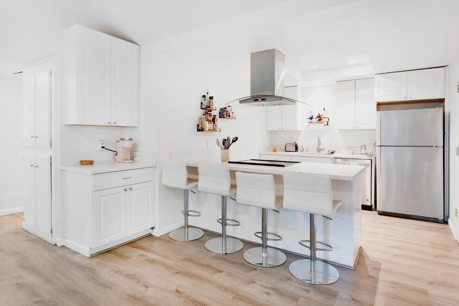 217 La Vida Way Davis, CA 95618 - Photo 11 of 18 a kitchen with appliances cabinets and wooden floor