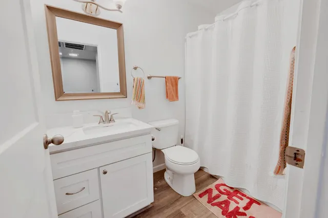 a bathroom with a sink toilet and vanity
