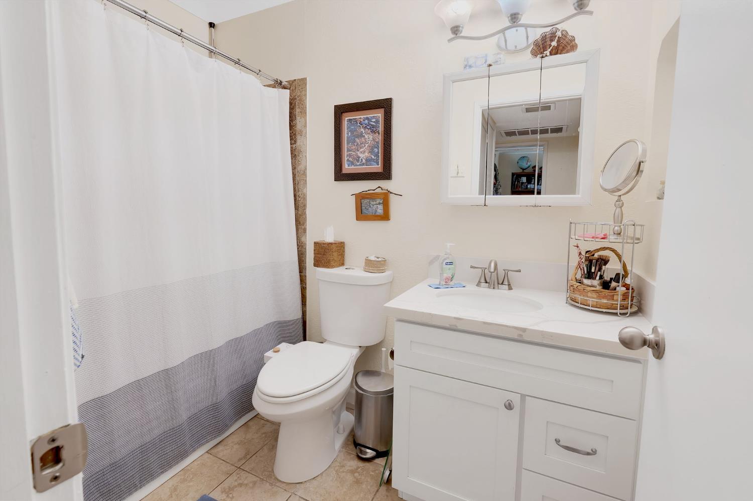 217 La Vida Way Davis, CA 95618 - Photo 6 of 18 a bathroom with a sink a toilet and a mirror