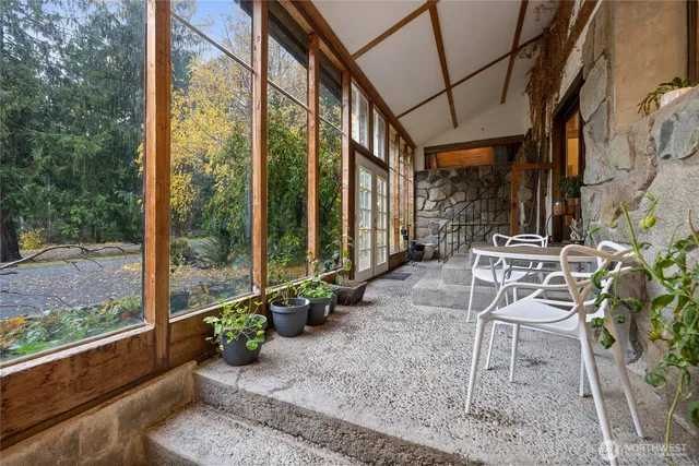 a house view with a sitting space and glass windows