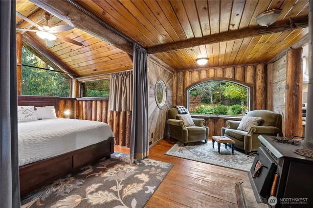 a bedroom with furniture and large windows