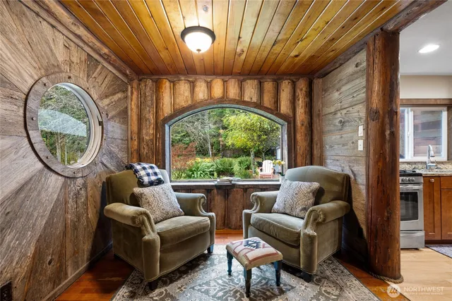 a living room with furniture a fireplace and a large window