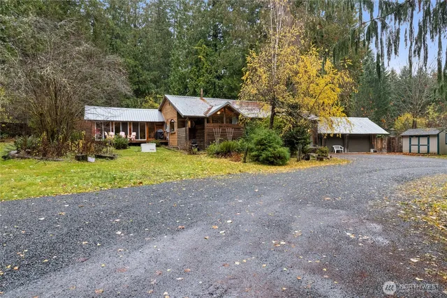 a view of a house with backyard and sitting area