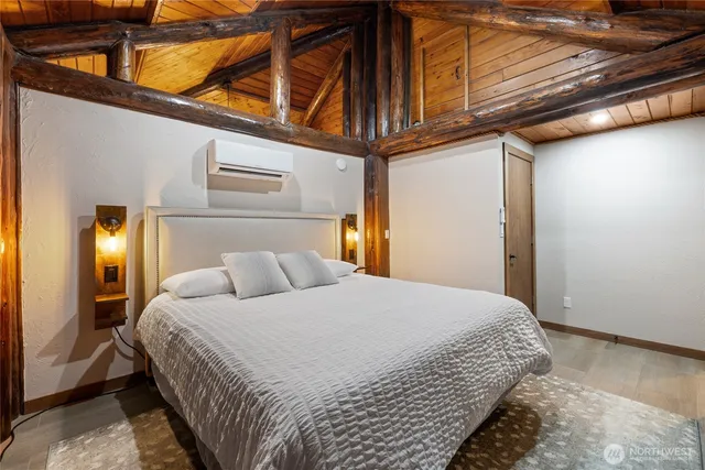 a bedroom with a bed a mirror and lamp