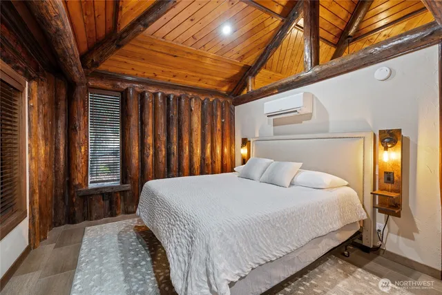 a bedroom with a bed next to a window