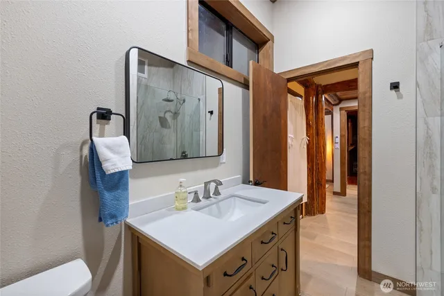 a bathroom with a sink vanity and a mirror