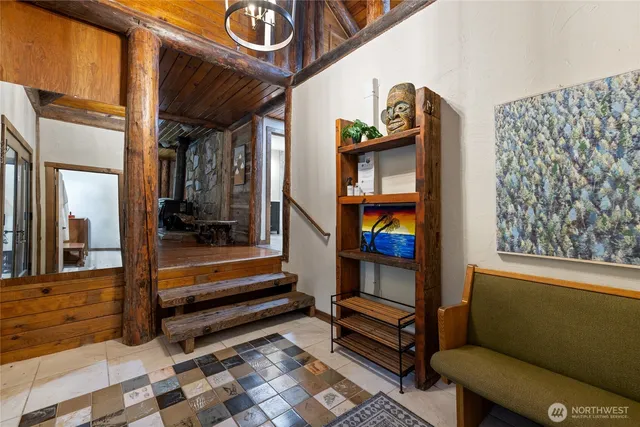 a view of entryway and hall with wooden floor