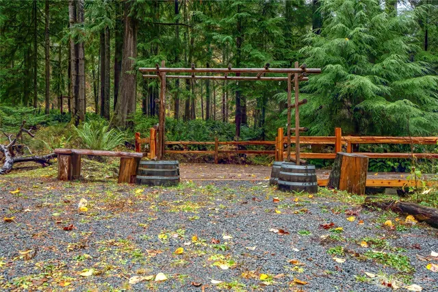 a view of a chair and tables in the back yard of the house