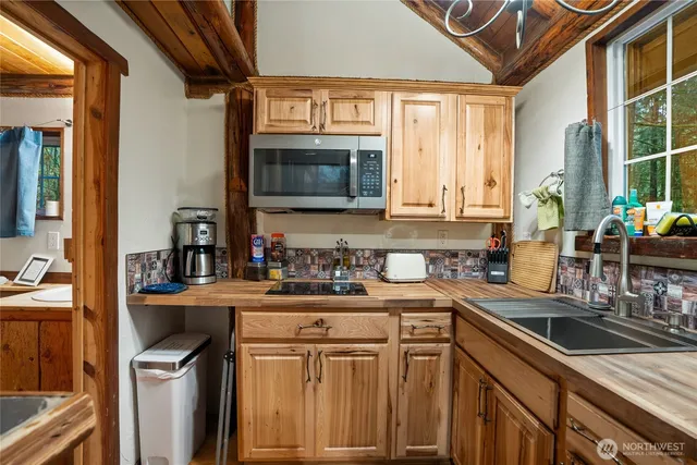 a kitchen with stainless steel appliances granite countertop a sink stove and cabinets