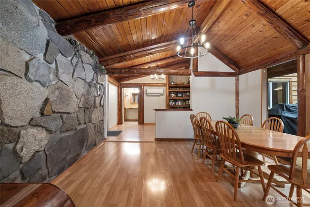 a dining room with furniture and wooden floor