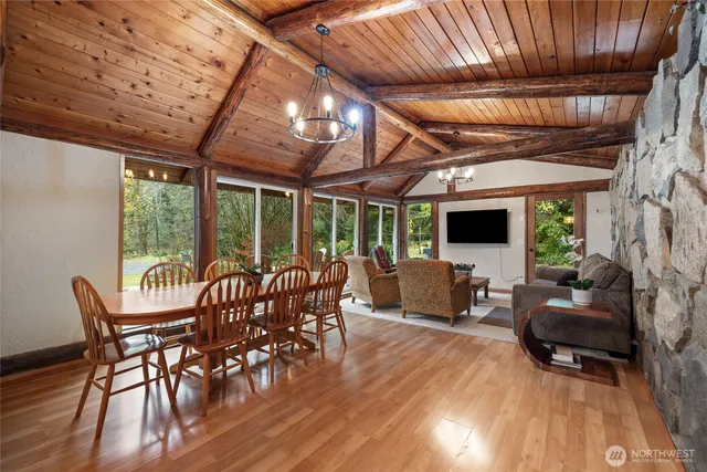 a view of a patio with table and chairs with wooden floor
