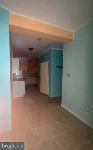 a view of kitchen and refrigerator