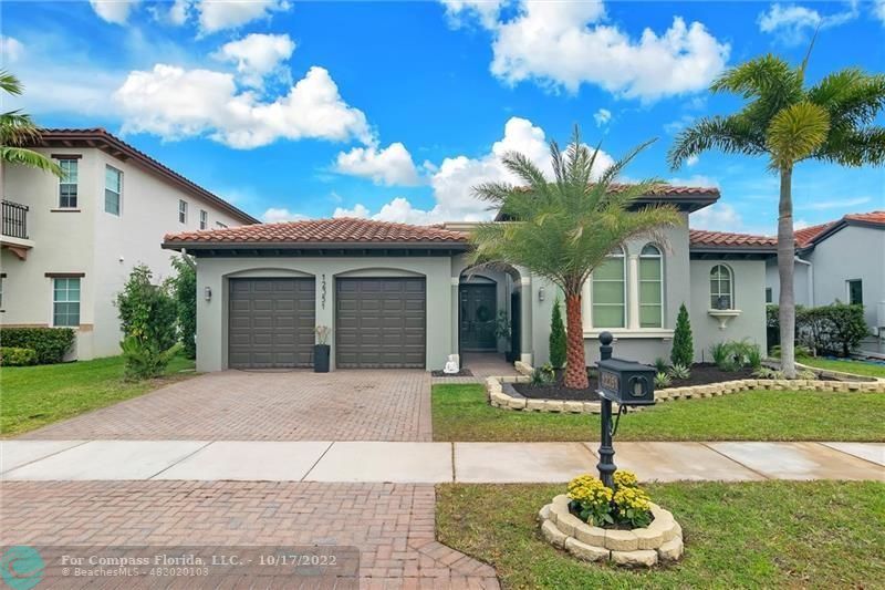 Heron Bay Parkland, FL 33076 - Photo 3 of 33 a front view of a house with garden and patio