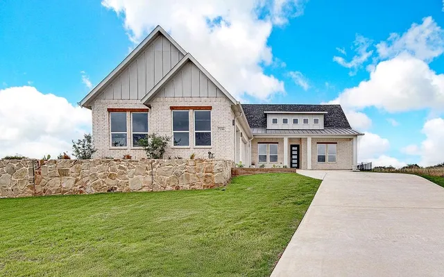 a front view of house with yard and green space