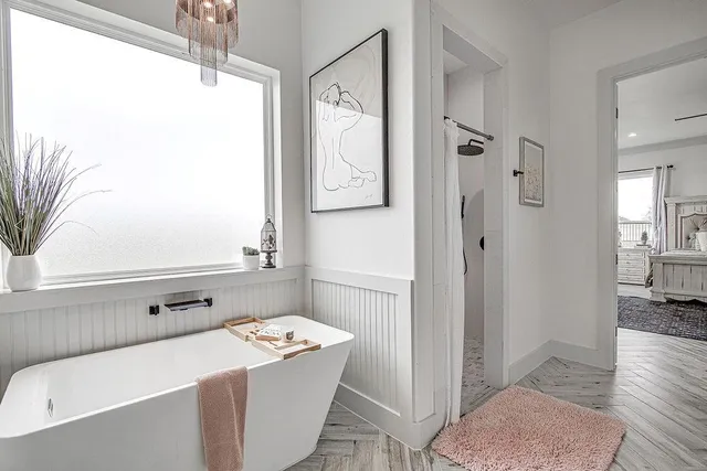 a bathroom with a tub sink and mirror